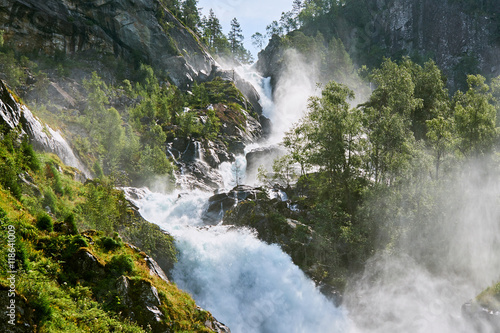 Cascades of water running from the top of the waterfall Laatefossen in Norway