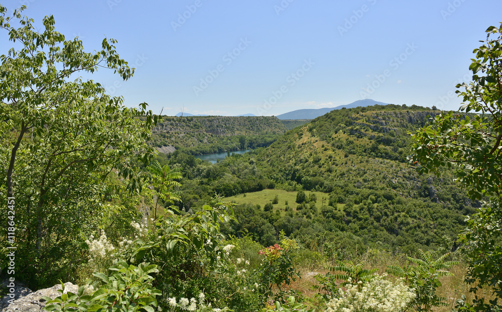 The landscape near Manojlovac Slap waterfall showing the River Krka in Krka National Park, Sibenik-Knin County, Croatia.
