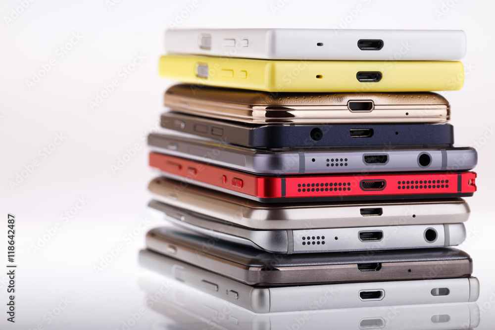 Pile of mobile phone. Heap of the different smartphones isolated Pile of mobile phone. Heap of the different smartphones isolated