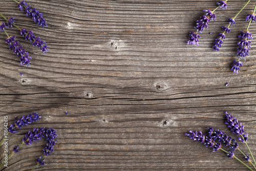 Fototapeta Naklejka Na Ścianę i Meble -  Lavender flowers on a wooden background. Floral border or frame