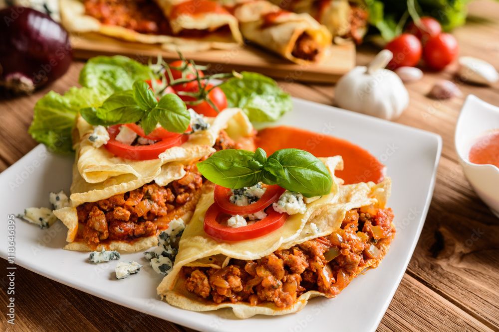 Pancakes stuffed with Bolognese filling - minced beef, pepper, onion, garlic and basil with tomato sauce Pancakes stuffed with Bolognese filling - minced beef, pepper, onion, garlic and basil with tomato sauce