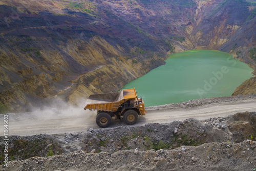 Yellow dump truck on coper surface mining