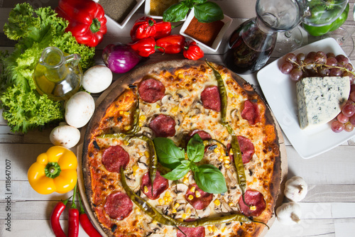 Lots of ingredients like vegetables, diary products, herbs and spices which are needes to preparation homemade pizza in Italian style.