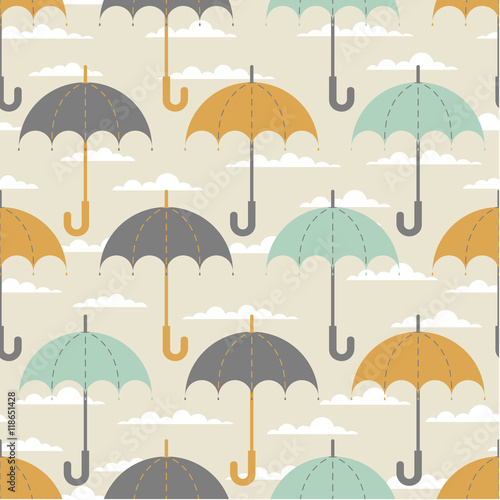 Seamless texture. Autumn. Depicts the umbrellas of the same size .Umbrella in three colors : grey, yellow and blue .Umbrellas in the clouds. Umbrellas on a beige background.