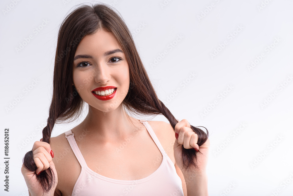 Cute young woman having fun with hairstyle Cute young woman having fun with hairstyle