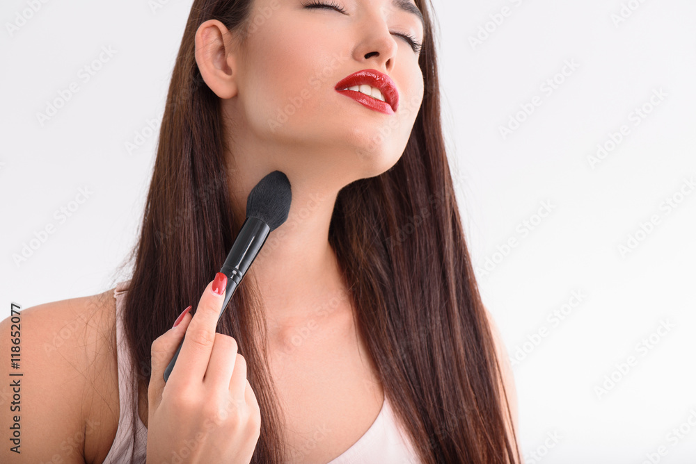 Beautiful girl applying make-up on body Beautiful girl applying make-up on body