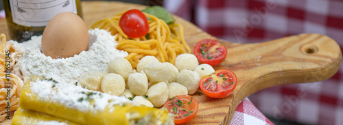 Photography pasta and tomato on chopping board