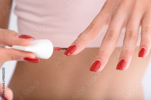 Stylish girl polishing her fingernails