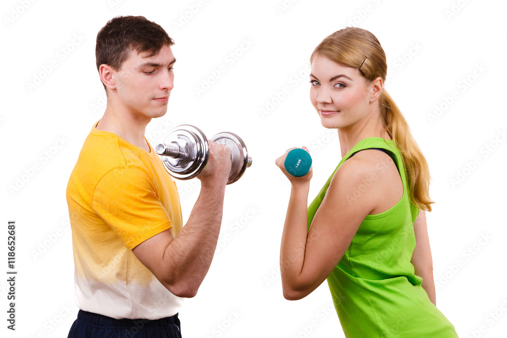 Couple exercising with dumbbells lifting weights Couple exercising with dumbbells lifting weights