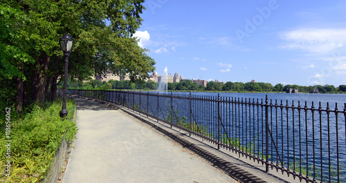 Central Park reservoir with fountain with Upper West Side skyline and blue sky with clouds, Manhattan, New York City © nyker
