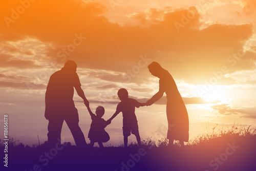 Happy family dancing on the road in the sunset time. Evening par