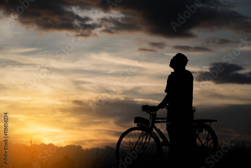 Silhouette of a bike on sky background on sunset