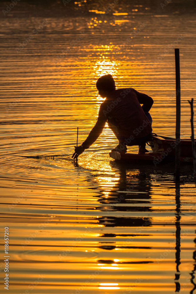 Fisherman in sunrise