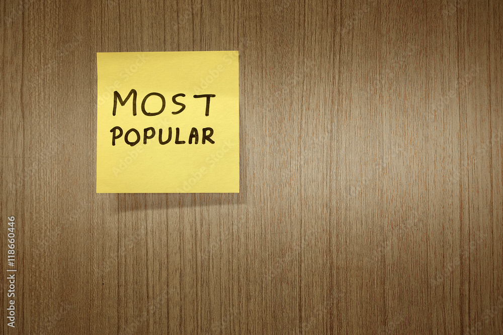 Most popular handwritten message on paper note on wooden background. Most popular handwritten message on paper note on wooden background.