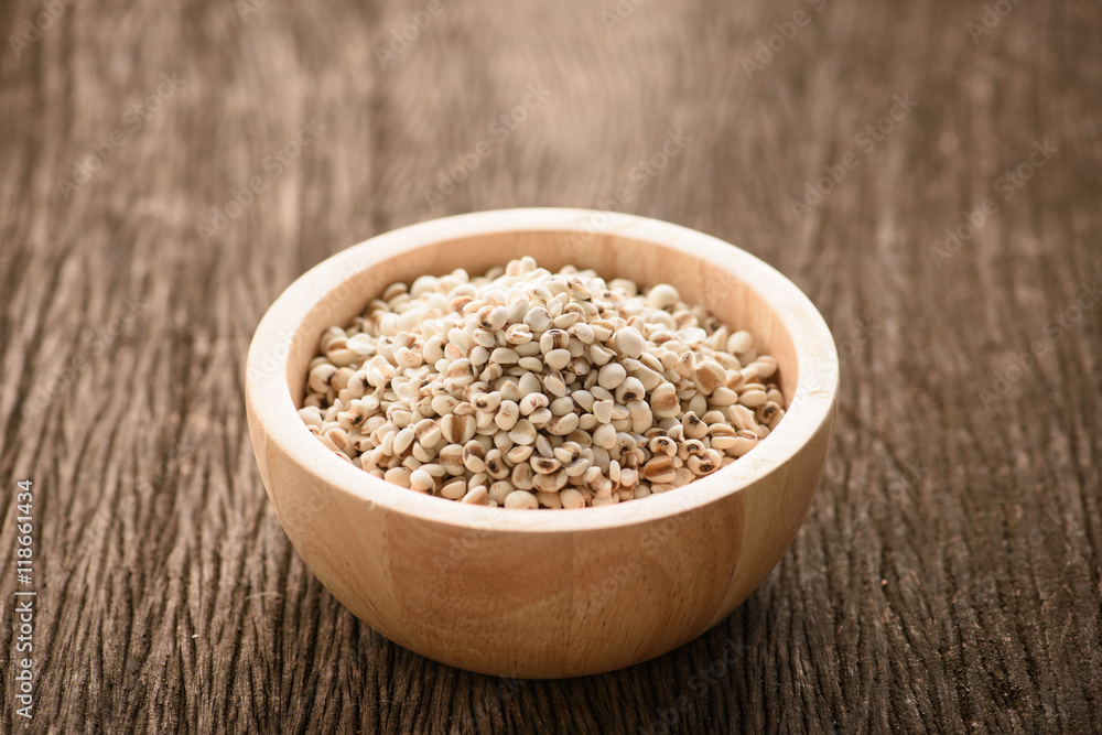 organic millet in a wood bowl on wooden rustic table organic millet in a wood bowl on wooden rustic table