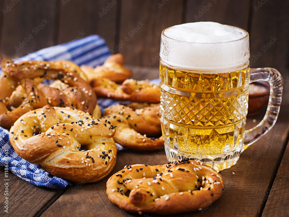 Oktoberfest salted soft pretzels in a bowl and beer from Germany on wooden background. Oktoberfest salted soft pretzels in a bowl and beer from Germany on wooden background.