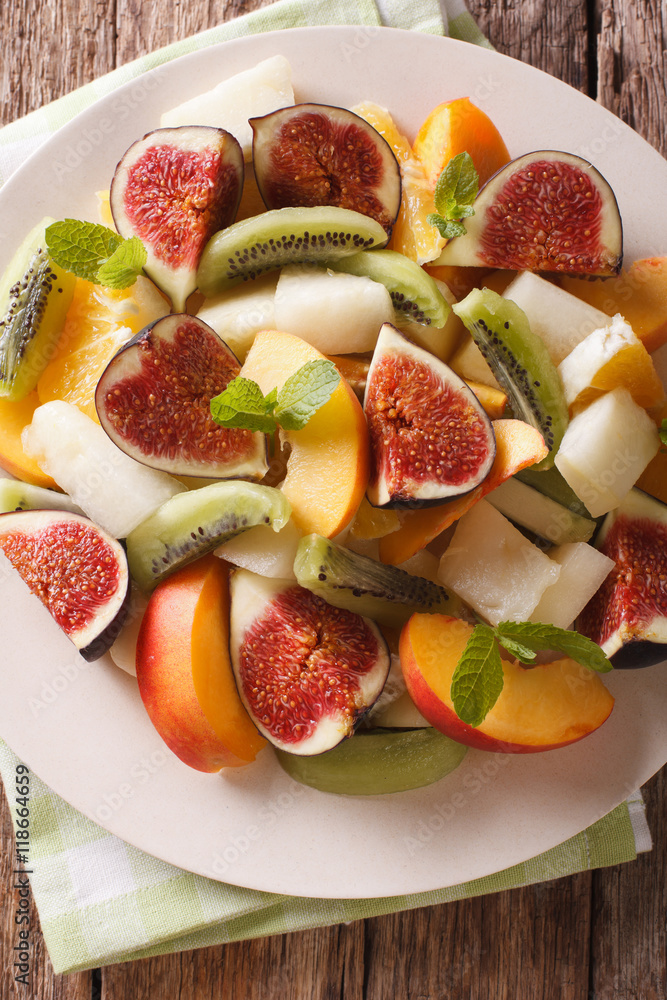 Salad of ripe fruit: figs, peaches, melons, kiwi and orange close-up. vertical top view
Salad of ripe fruit: figs, peaches, melons, kiwi and orange close-up. vertical top view