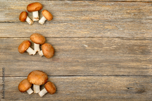 champignon mushrooms on a wooden boards background