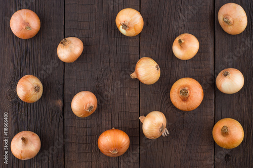 Onions on old wooden table.