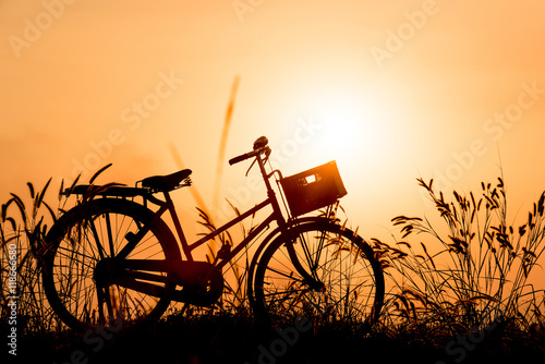 beautiful landscape image with Silhouette vintage Bicycle at sun © Looker_Studio