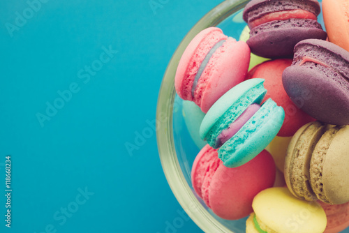 Colorful france macarons on blue background.