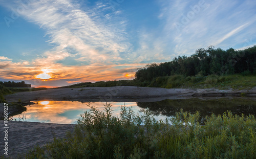 The reflection of the sunset in a small pond