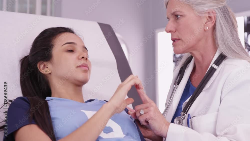 Hispanic athlete having head injury examined by doctor Hispanic athlete having head injury examined by doctor