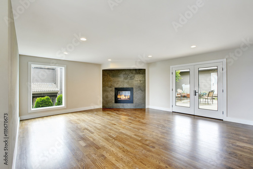 Empty living room interior in light tones with fireplace.