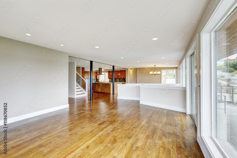 Fototapeta premium Open floor plan. Empty living room interior in light tones