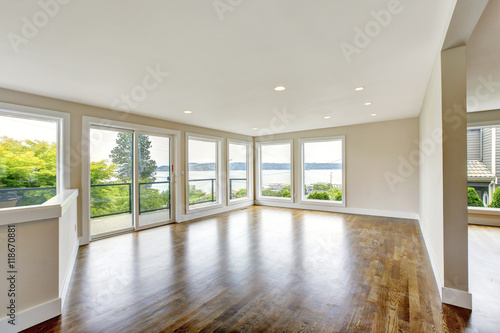 Empty living room interior in light tones with hardwood floor