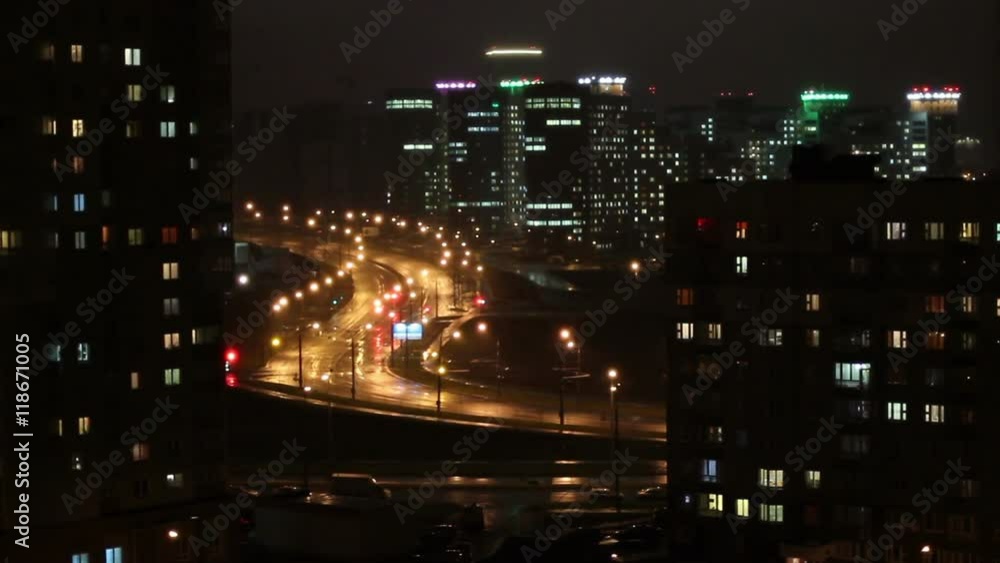 Night city. Cars are going along night road. Traffic lights are flashing green and red color. Night city. Cars are going along night road. Traffic lights are flashing green and red color.