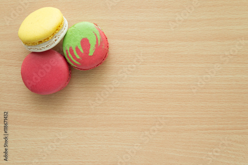 Colorful france macarons on wooden table background.