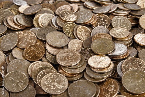 Heap of the coins on wooden background. Stock image macro.
