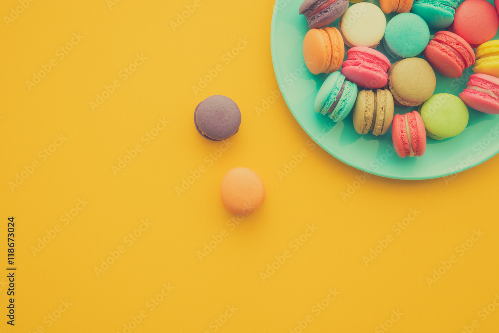 Colorful france macarons on yellow background Colorful france macarons on yellow background