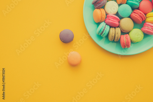 Colorful france macarons on yellow background