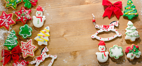 Christmas cookies with decorations on wooden table.