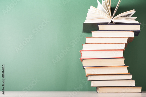 Open book, hardback books on wooden table. Education background. Back to scho...