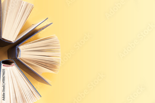 Open book, hardback books on wooden table. Education background. Back to school. Copy space for text.