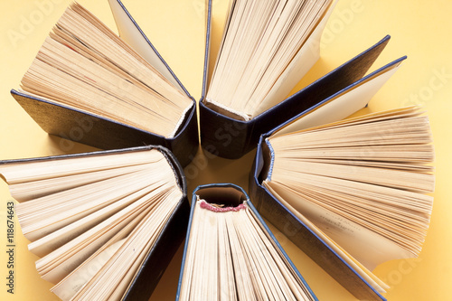 Open book, hardback books on wooden table. Education background. Back to school. Copy space for text.