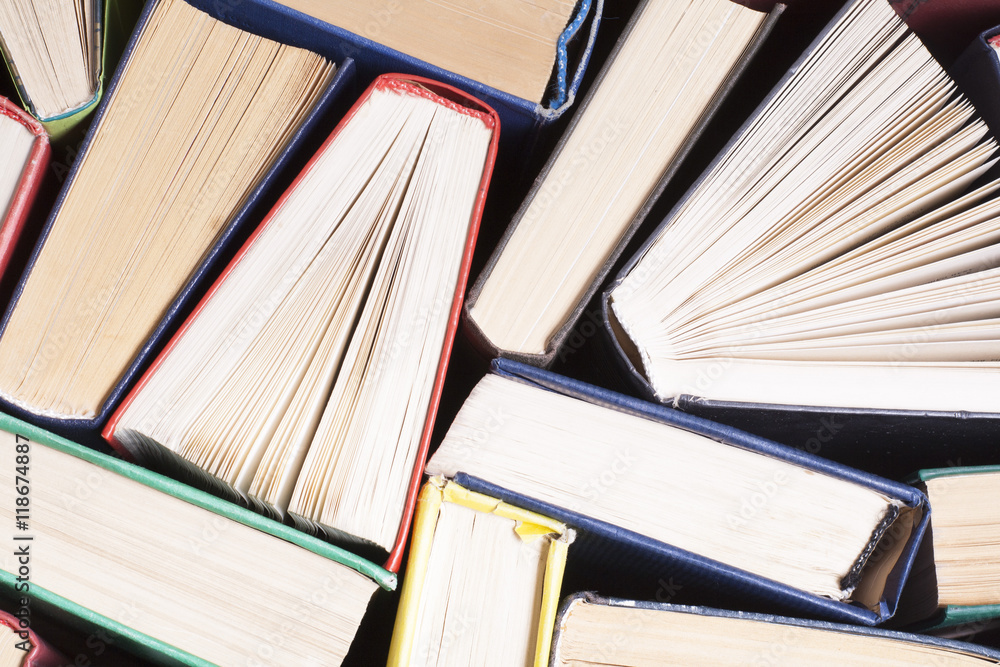Naklejka premium Open book, hardback books on wooden table. Education background. Back to school. Copy space for text.