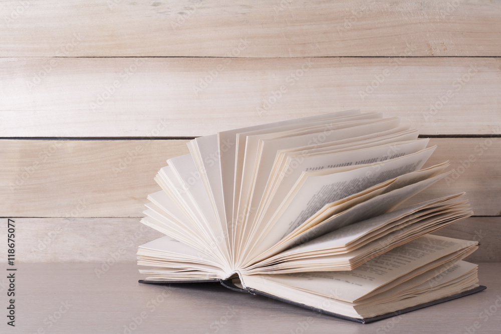 Open book, hardback books on wooden table. Education background. Back to school. Copy space for text. Open book, hardback books on wooden table. Education background. Back to school. Copy space for text.