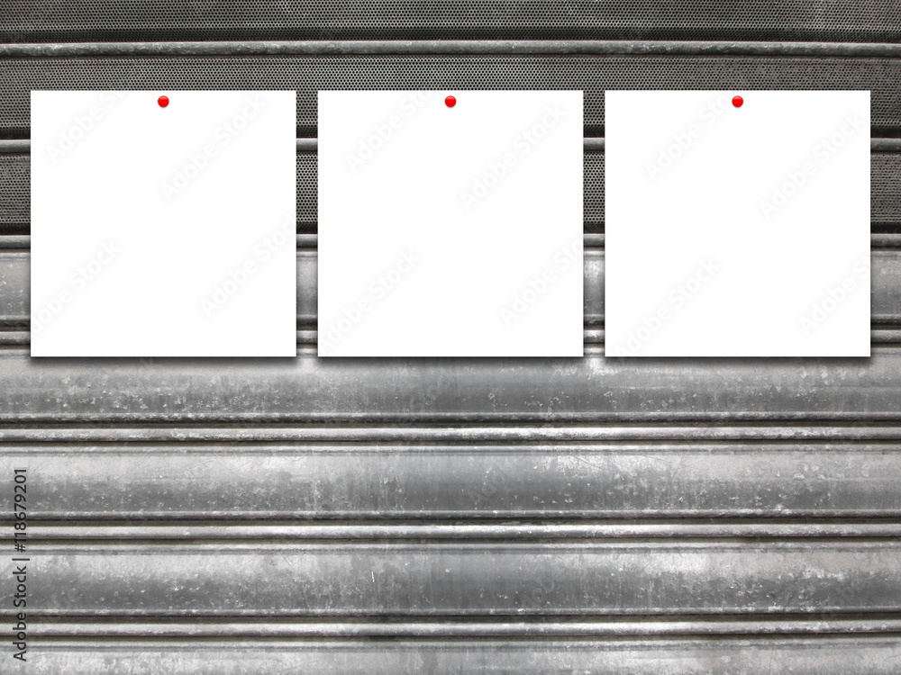 Close-up of three square blank frames with red pins on gray old metal shutter background Close-up of three square blank frames with red pins on gray old metal shutter background