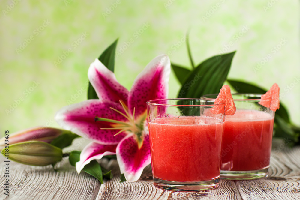 Glass of watermelon smoothie with lily Glass of watermelon smoothie with lily