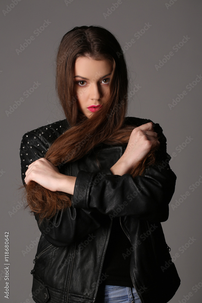 Lady with makeup in a studded leather. Close up. White background Lady with makeup in a studded leather. Close up. White background