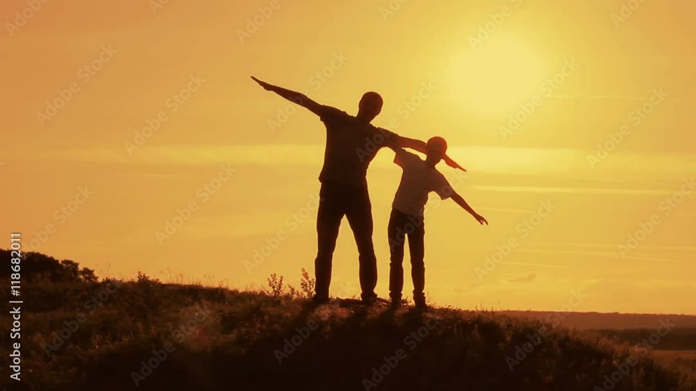 Silhouettes of the pope and his son at sunset