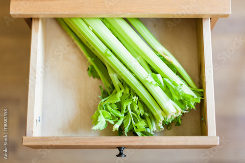 green celery stalks in open drawer