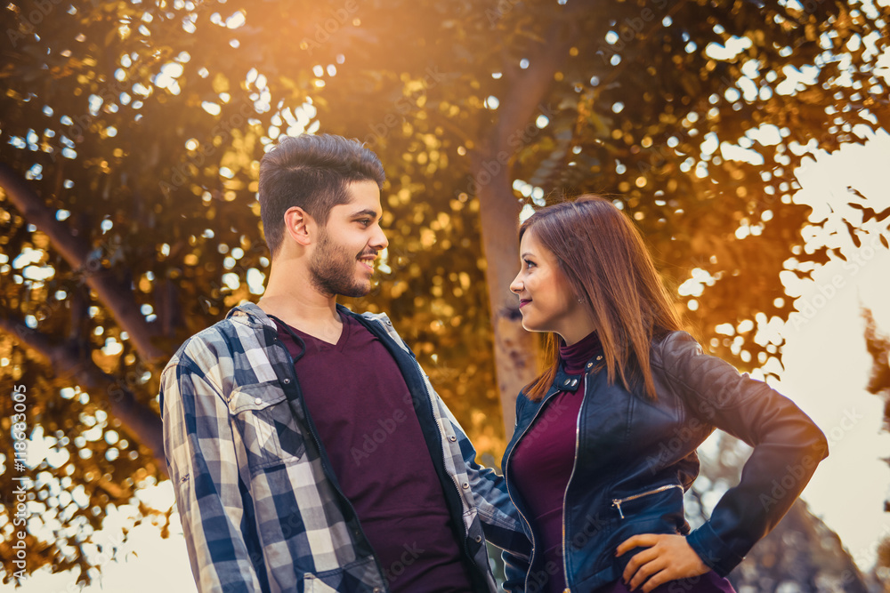 Fototapeta premium Young couple spends time in the autumn park
