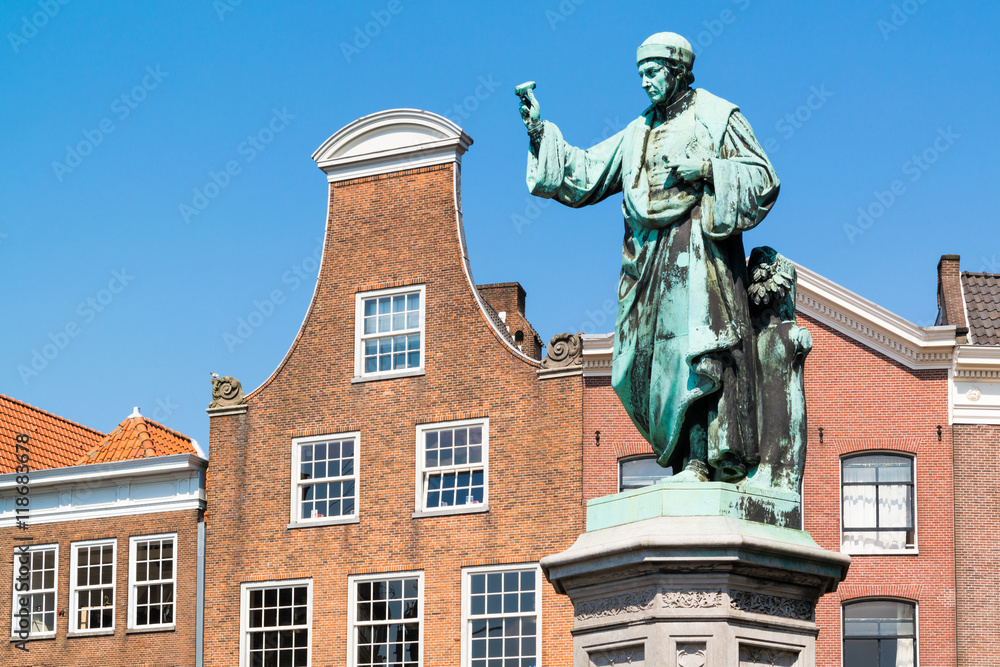 Statue of Laurens Janszoon Coster and bell gable of old house on Grote Markt market square in downtown Haarlem, Netherlands