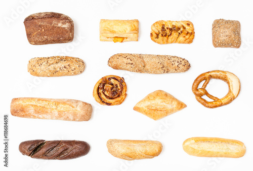 various fresh buns and loaves on white background