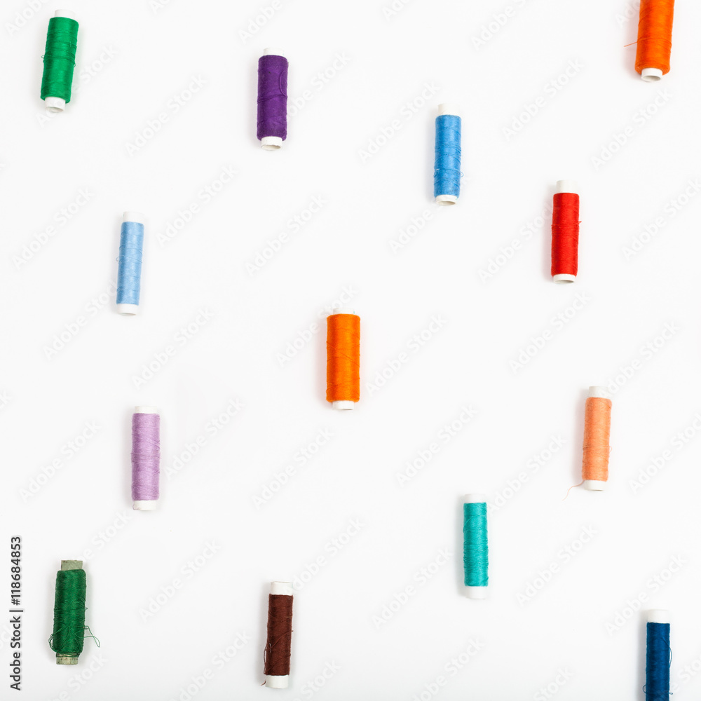 several spools of sewing thread on white several spools of sewing thread on white